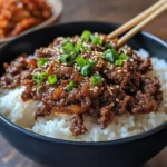 Korean ground beef bowl with sesame seeds and green onions
